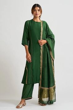 Emerald green asymmetric hem A line kurta in hand embroidered dabka work. Paired cotton silk palazzo with floral embroidered hem and sheer chanderi dupatta broad gold hem.
Component: 3
Pattern: Hand embroidered
Type Of Work: Thread work, Gota patti
Neckline: High neck
Sleeve Type: Three quarter
Fabric: Cotton silk, Chanderi
Color: Green
Other Details: 
Piping detail
Side pocket
Occasion: Sangeet ,Work - Aza Fashions Luxury Green Unstitched Straight Kurta Suit, Kurta Palazzo Set, A Line Kurta, Palazzo Set, Suits Design, Indian Fashion Designers, Silk Embroidery, Kurta Designs, Thread Work