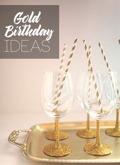 four wine glasses on a tray with straws in them and the words gold birthday ideas