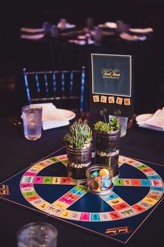 a board game set up on top of a table with succulents in pots