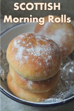 three powdered doughnuts in a bowl with the words scottish morning rolls