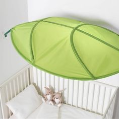 a green canopy over a white crib