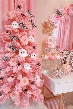 a pink christmas tree with black and white decorations