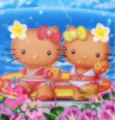 two hello kitty dolls sitting on top of a boat in the water with flowers around them