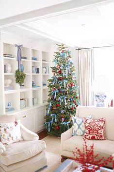 a living room with a christmas tree in the corner