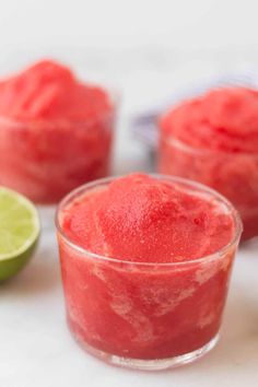 watermelon sorbet in small glass bowls with limes on the side