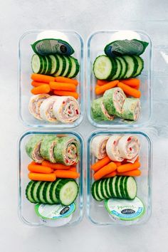 four plastic containers filled with veggies and meat wrapped in cucumber slices