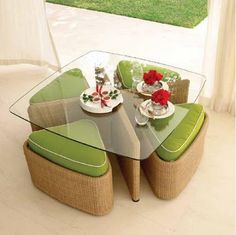 a glass table with chairs and plates on it