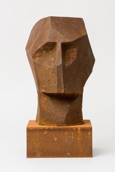 an abstract sculpture made out of concrete on a white background with the image of a man's head