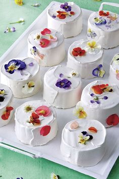 there are many small cakes with flowers on them