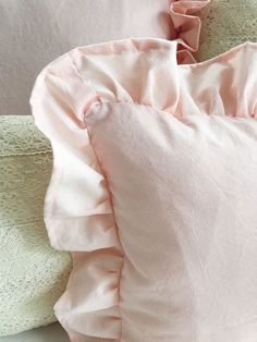 a pink pillow with ruffles on it