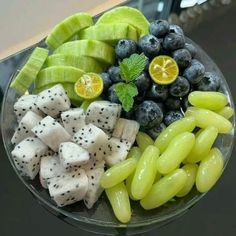 a glass bowl filled with fruits and vegetables