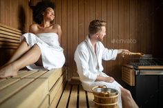 a man and woman sitting in a sauna