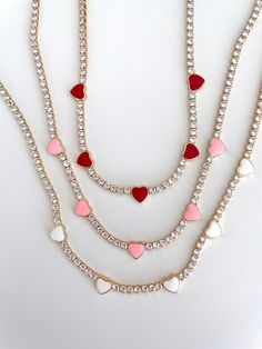 Girl things all the way <3 Meet our latest tennis necklace that features the sweetest enamel hearts and is adjustable. 14 Gold-plated over brass and hypoallergenic, this holiday season & beyond everyone will be envious of your neck candies. Perfect for layering. Measures at 13 inches with 2" extension. Trendy White Necklace For Valentine's Day, Adjustable Tennis Necklace For Gift, Girl Things, Resin Ring, Tennis Necklace, The Way, Holiday Season, Layering, Tennis