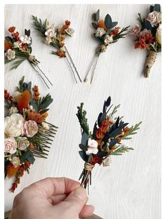 someone is arranging flowers on the table with their hair pins and combs to make them look like they have been pinned together