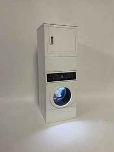 a washing machine sitting on top of a white floor