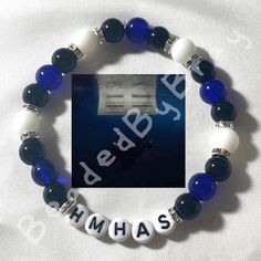 a blue and white beaded bracelet with the words ahas on it in silver