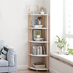 a room with a couch, table and bookshelf in front of the wall