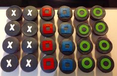 several cupcakes with different colored icing designs on the top and bottom are arranged in rows