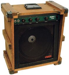 an old style amp sitting on top of a wooden stand