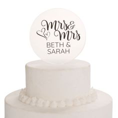 a white wedding cake with a mr and mrs topper