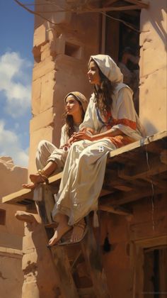 two women sitting on the ledge of a building in front of a blue sky with clouds