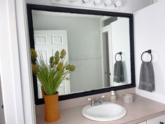 a bathroom sink with a large mirror above it