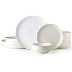 the white dishes are stacked on top of each other, with one bowl in front