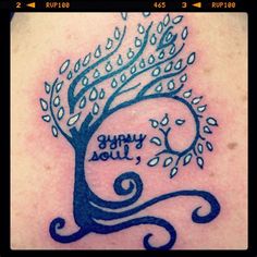 a tattoo with a tree on it and the words happy new year written in cursive writing