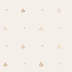 a white wall with gold leaves and dots on the bottom half of it, in front of a beige background