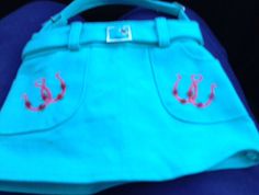 a blue purse with pink anchors on it