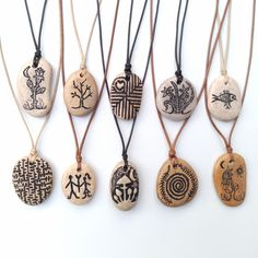 several different types of stone pendants hanging from cords