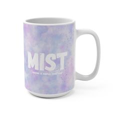 a coffee mug with the words mist on it in white and purple paint splatters