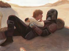 a man laying on the ground with a helmet on his head next to a star wars character