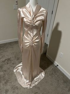 This one-of-a-kind art deco wedding gown from the 1930s is truly a work of art. Gorgeous details include the v-neck accented by the fold down collar and the figure-flattering ruching in the center of the bodice and pelvic area. The gown has snaps up the left side and a long slinky belt that ties in the back. The finishing touch is the fishtail train in the back. Just phenomenal! Based on how it hugs my mannequin, I'd estimate the dress is size 2-4. This beauty is in excellent vintage condition w Gatsby Style Fitted Wedding Evening Dress, Fitted Gatsby Style Wedding Evening Dress, Elegant Evening Dress For Vintage Events With Fitted Bodice, Vintage Satin Evening Dress For Wedding, Fitted Vintage Floor-length Evening Dress, Vintage Floor-length Fitted Evening Dress, Vintage Fitted Floor-length Evening Dress, Fitted Floor-length Vintage Evening Dress, Fitted Evening Dress For Vintage Events