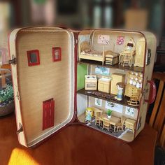 an open suitcase sitting on top of a wooden table