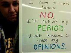 a woman holding a sign that says i need feminist because no period just because my opinions