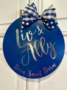 a blue sign that says live and love with a bow on it's front door