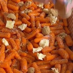 carrots and cheese are mixed together in a bowl