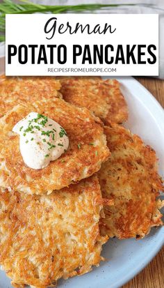 a white plate topped with potato pancakes covered in sour cream and sprinkled with chives