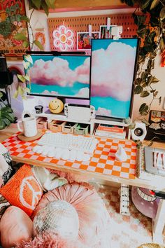 a desk with two computer monitors and a keyboard on it in front of a plant