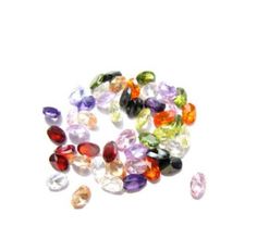 many different colored stones on a white surface