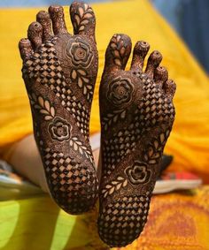 two hands with henna designs on them