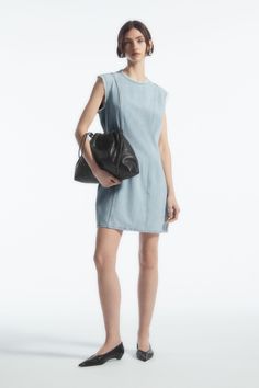 This paneled mini is our womenswear team's contemporary take on '60s shift dresses. It's crafted from organic-cotton denim that's blended with fluid TENCEL™ Lyocell and has a round neck, a tasseled zip pull and modern frayed edges. Complement the short hemline by styling it with knee-high boots. Slim fitZip closureOrganic cotton is grown from non-genetically modified seeds without chemical fertilizers or pesticides Shell: 62% Organic cotton, 38% TENCEL™ Lyocell. Excluding trims / Machine wash Ba Relaxed Fit Mini Denim Dress For Work, Summer Denim Mini Dress For Work, Summer Workwear Denim Mini Dress, Spring Everyday Mini Dress, Everyday Spring Mini Dress, 60s Shift Dress, Summer Wishlist, Shift Dresses, Genetically Modified