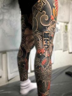 a man with tattoos on his legs and leg