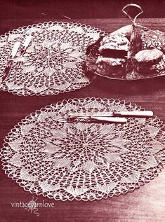 three crocheted doily are sitting on a table next to some pastries