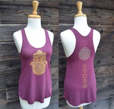 Sacred Geometry Hamsa Hand Tank Top - Women's Yoga Tank Top - Festival Tank Top This comfortable American Apparel racerback tank top features a metallic gold and glow in the dark sacred geometric Hamsa Hand design. The gold print on this top also has the five platonic solid shapes printed in the fingers in glow in the dark ink, as well as a glow in the dark seed of life over the main mandala. The back of this tank top is finished off with another smaller double layer print of my Seed of Life man Fitted Racerback Top For Festivals, Fitted Racerback Tank Top For Festival, Screen Printed Clothing, Sacred Geometry Clothing, Festival Crop Tops, Sacred Geometric, Platonic Solid, Yoga Tank Top, Solid Shapes