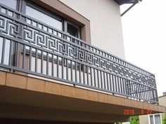 an apartment building with a balcony and metal railing