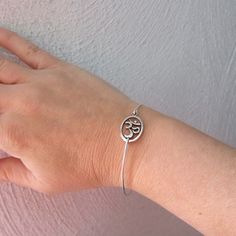 Silver Om Bracelet - A silver tone Om sign has been transformed into an Om bangle bracelet with a silver filled band for you to wear. I can also make this Om bracelet with a sterling silver band for an additional $10. If you would like this option for your Om symbol jewelry, select from options when ordering your Chakra bracelet. This Om stacking bangle looks great together with others from my collection as you can see from the last picture. Have fun stacking your yoga bangle bracelet with other Adjustable Hypoallergenic Silver Bracelet, Adjustable Silver Jubilee Bracelet Bangle, Symbolic Nickel-free Silver Bracelets, Adjustable Symbolic Bangle, Adjustable Sterling Silver Symbolic Bracelet, Adjustable Symbolic Sterling Silver Bracelet, Sterling Silver Symbolic Adjustable Bracelet, Symbolic Sterling Silver Adjustable Bracelet, Nickel-free Silver Spiritual Bangle