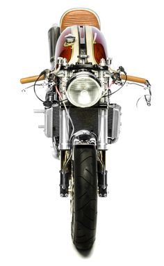 the front end of a motorcycle with an orange and white stripe on it's side