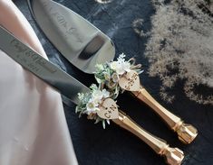 two gold wedding forks with flowers on them and a knife next to it that says congratulations